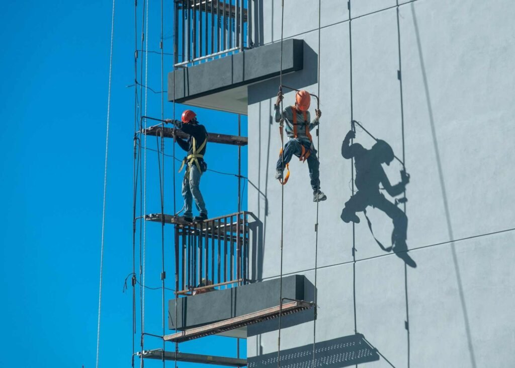 couple workers fixing climbing scaffolding while following all safety measures 1